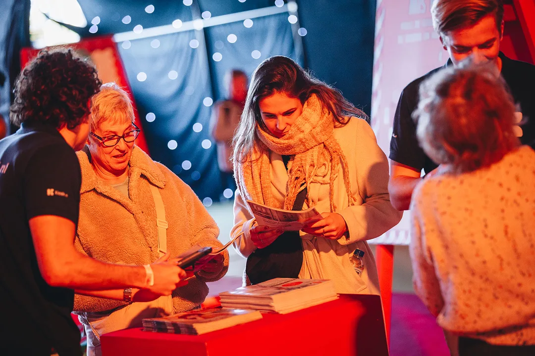Standhouder in gesprek met bezoekers bij de stand
